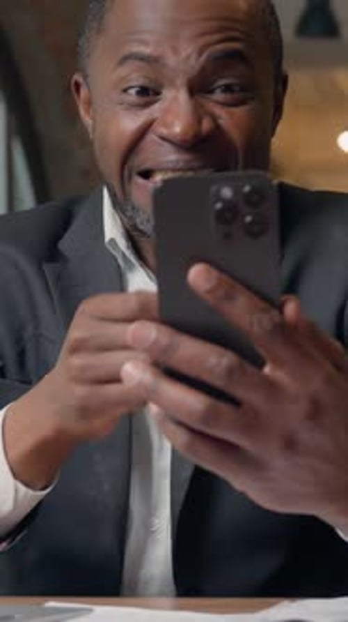 African American Business Man Businessman Winning with Mobile Phone Web Prize Virtual Casino Bet