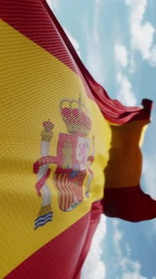 Waving Spanish Flag on Blue Sky Background Vertical Video