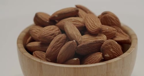Wooden Bowl Full of Fresh Almonds Close Up