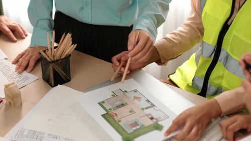 Architects discussing about house construction design. Closeup. Delineation.