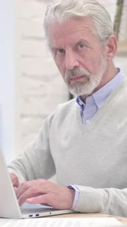 Smiling Old Man in Office Looking at Camera, Vertical Video