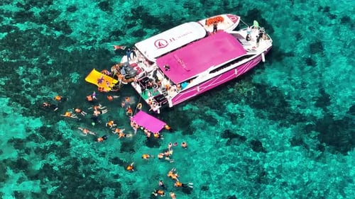 Aerial view of boat with swimmers, Thailand.