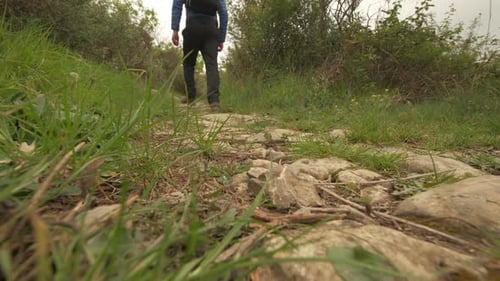 Low angle of man hiking walking in mountain path, trekking adventure
