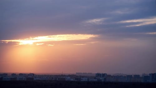 Sun shines through the clouds, overcast. timelapse. The sun's rays break through the black clouds