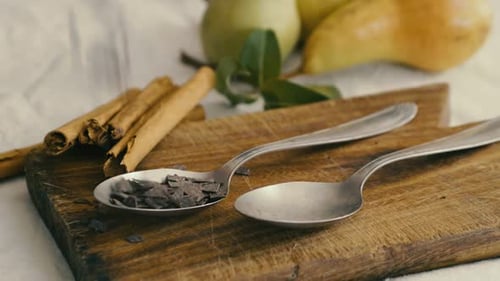 Chocolate Shavings Being Added to Spoon with Cinnamon