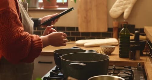 Adult Using Tablet to Cook at Home