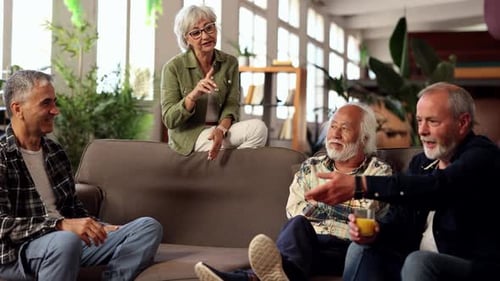 Senior Adults Conversing on Couch Indoors