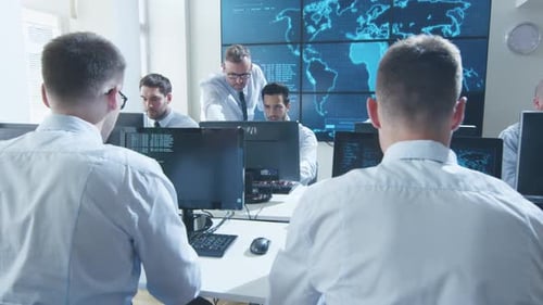 Team IT Security Professional Working in Bright Monitoring Room Filled with Displays
