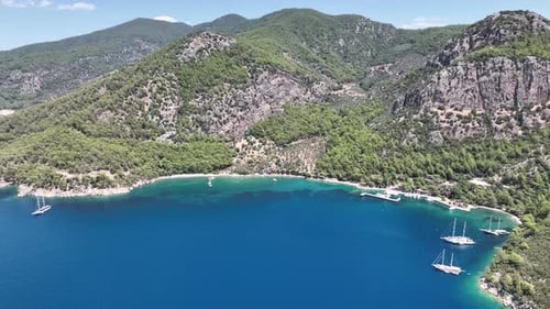 A stunning, scenic bay with a white sandy beach, shot from above.