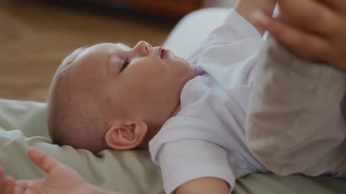 Happy Baby Playing on Blanket Indoors in Daytime