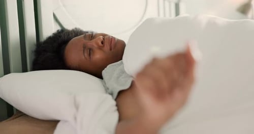 Woman Wakes Up and Stretches in Bed