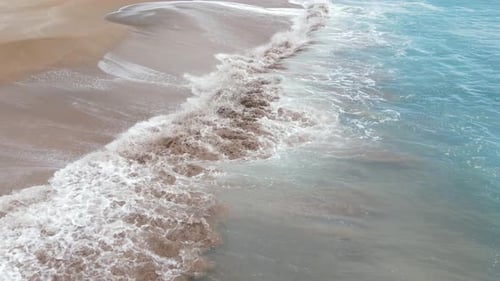 Sea waves and beach aerial view, side view, natural background.