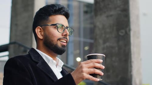 Happy Indian Business Man Enjoying Morning Coffee Hot Drink Relaxing Taking a Break in Downtown City