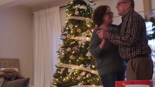 Romantic Senior Couple Dancing, Children Sleeping By Christmas Tree