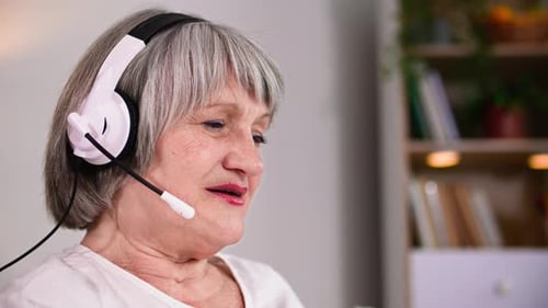 Smiling Adult Using Headset for Video Call