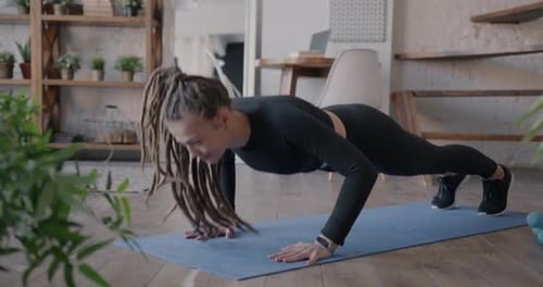 Woman Exercising Doing Pushups on Yoga Mat