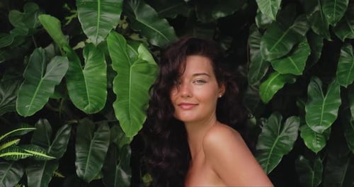 Beauty Spa Portrait of Young Woman Among Exotic Tropical Foliage