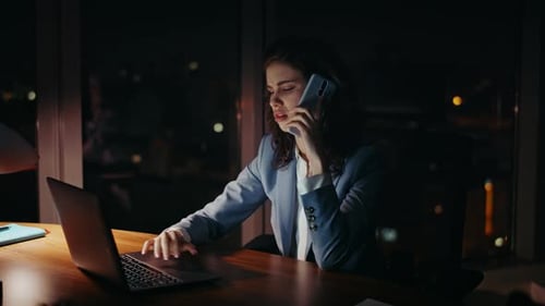Exhausted Business Woman Calling Telephone Working on Laptop Evening Close Up