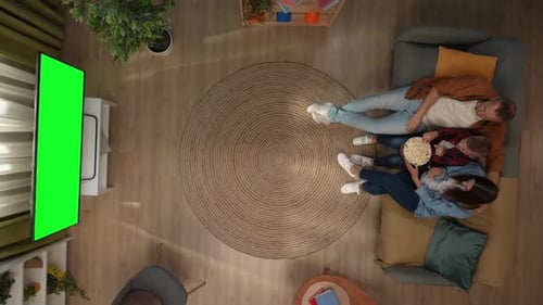 Top View of Living Room Mother Father and Son Sitting on the Sofa Watching Tv with Chroma Key Green