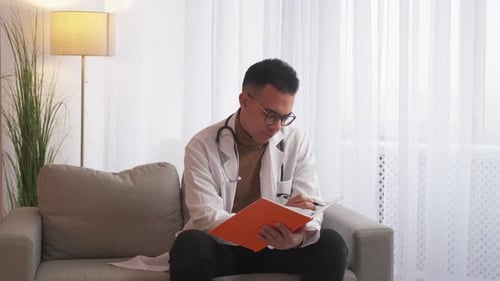 Medical Record Male Doctor Writing on Clipboard