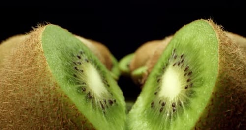 Fresh juicy kiwi fruit cut in half super close up shoot fly over 4k high quallity shoot on dark back