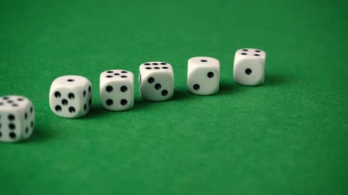 Slow moving shot of dices on a game table.