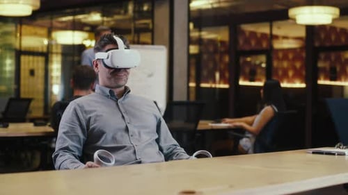 Man Speaking Online in VR Headset in Office