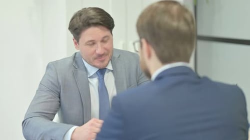 Businessman Talking with Customer in Office