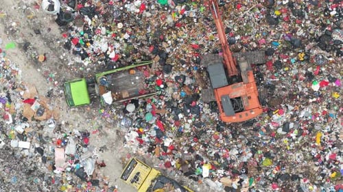 Aerial View: Excavator Loading Garbage Truck at Landfill Site