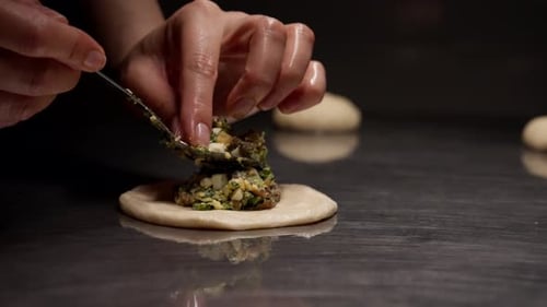 Filling Dough with Savory Mixture Close Up at Home