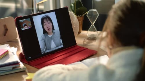 Child Having Video Call on Tablet at Desk