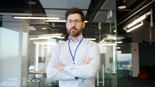 Portrait of IT engineer admin standing confidently in office with arms crossed. Serious developer