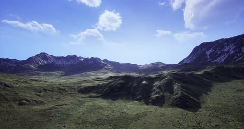 Scenic Mountain Landscape with Vibrant Green Fields Under Clear Blue Sky
