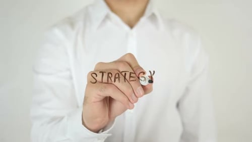 Man Writes Strategy on Clear Surface