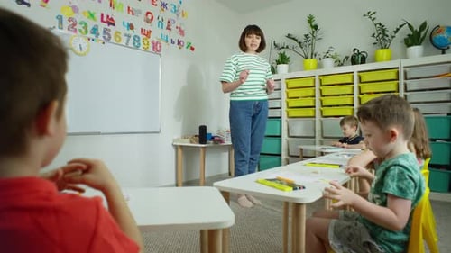 Teacher Interacts With Young Students in Classroom