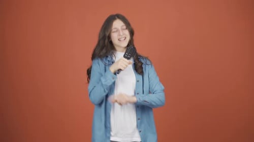 The young woman is singing.