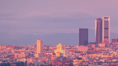Madrid skyline south view during sunset timelapse day to night. Cinco torres business area and Plaza