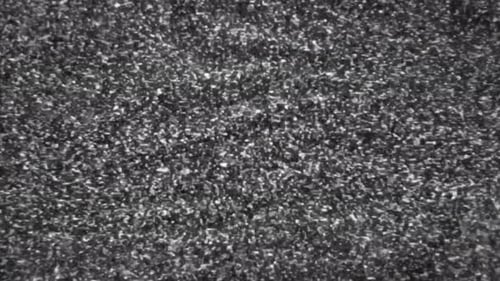Vintage television displaying grainy black and white static noise. Powered off at the end. Classic a