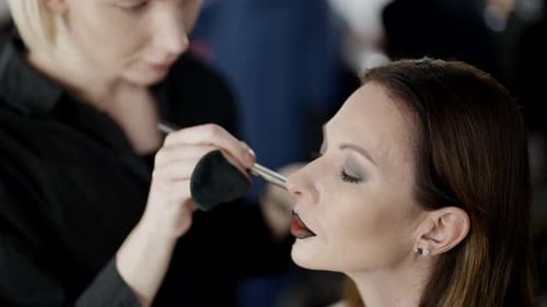 Makeup Artist Gay and Beautiful Middleaged Model Woman in Beauty Studio Preparing to Fashion Show