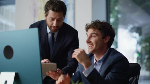 Boss Showing Colleague Tablet Ideas Discussing Project in Modern Office Closeup