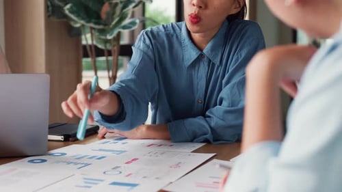 Asia people meeting brainstorming ideas about new paperwork project in office.