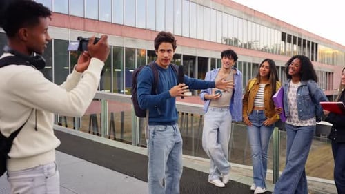 Young Student Filming a Friend with a Camera on the University Campus