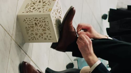 Man Tying Laces on Leather Dress Shoe