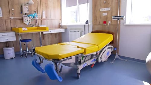 Technological modern wheeled bed in the centre of delivery room.
