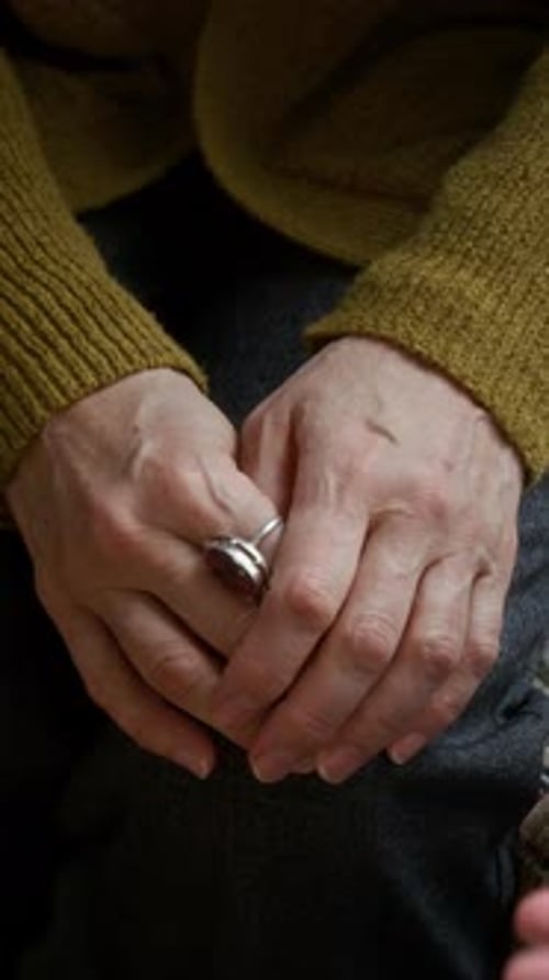 Close-Up of Caring Woman Gently Holding Hands of Elderly Lady