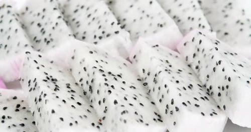 Close Up White Dragon Fruit Pulp Rotation Shot. Pitahaya Sliced Pieces Background