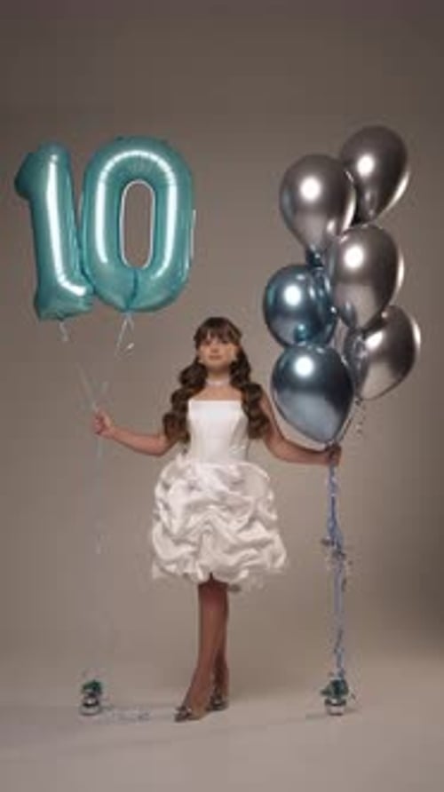 Girl Celebrating Tenth Birthday Holding Balloons Girl Celebrating Tenth Birthday Holding Balloons