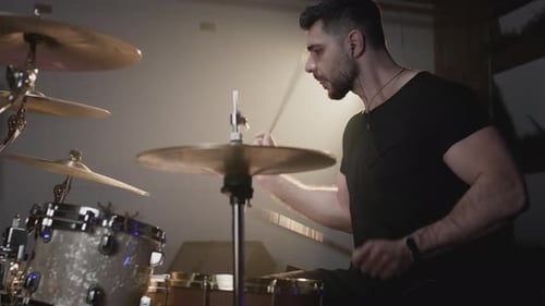 A Handsome Guy Plays Drums in a Recording Studio