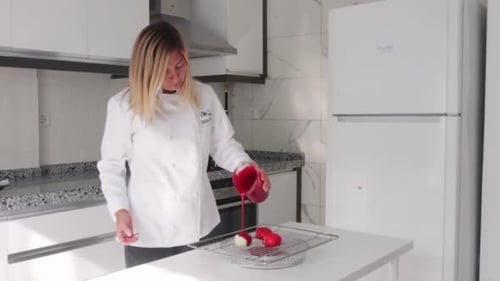 Chef Glazing Desserts in Modern Kitchen