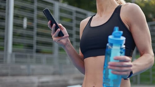 Blonde Woman with Phone and Water Bottle